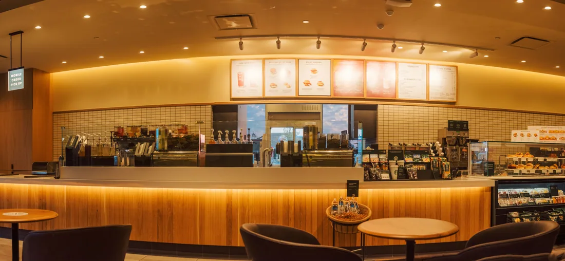 Café counter with a lit menu board